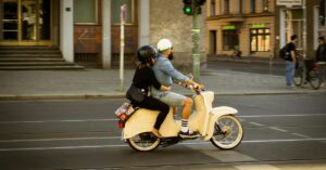 couple on motorcycle with helmets