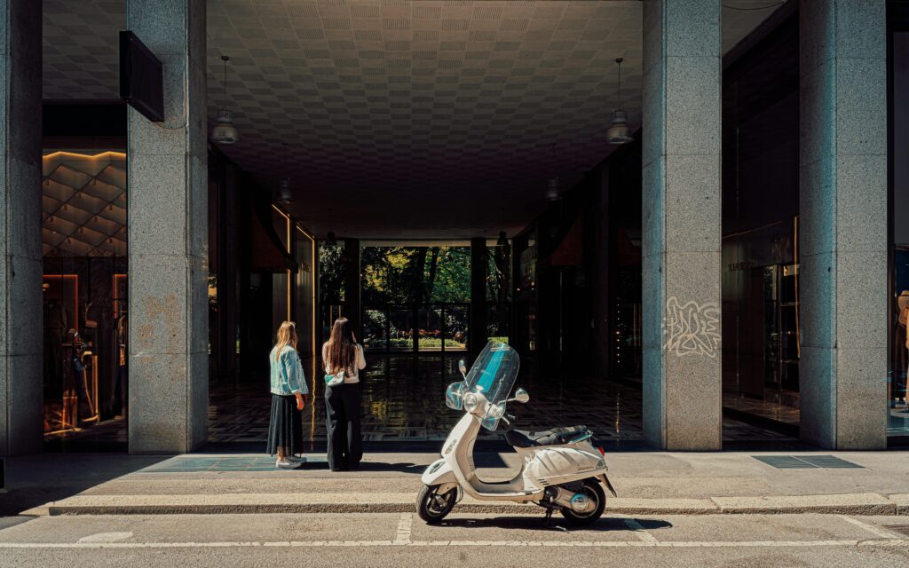 two women next to scooter