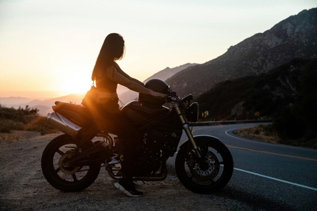 women on motorbike sunset