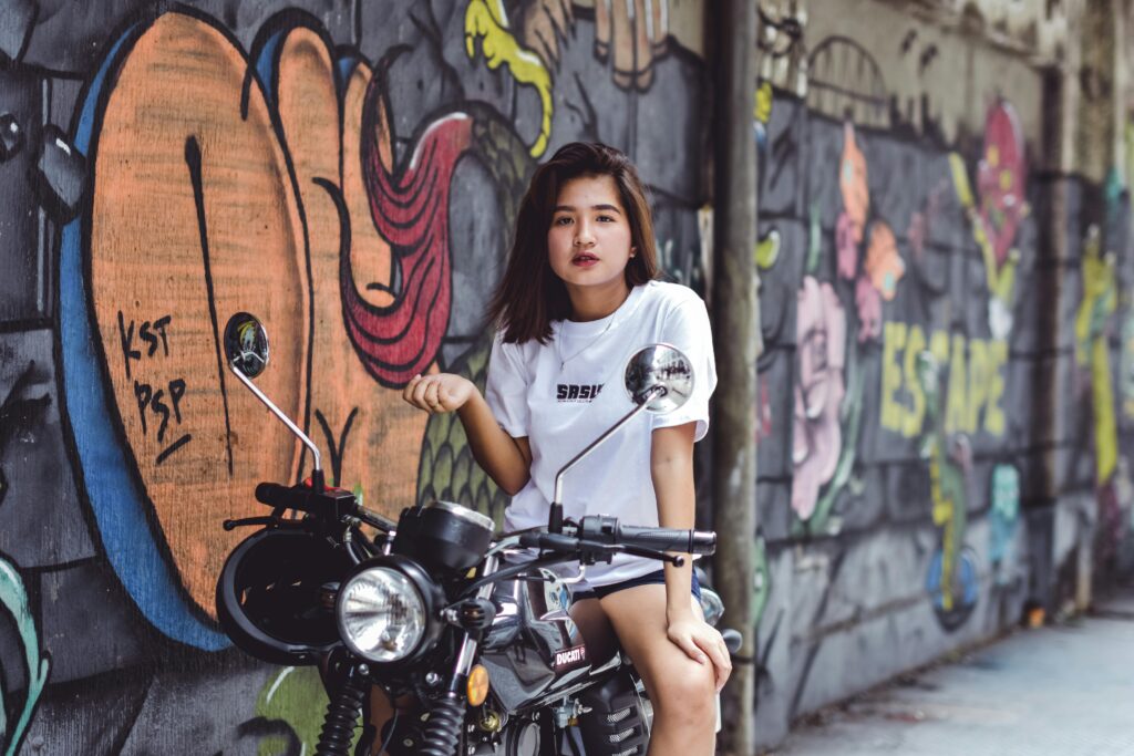 woman on bike with graffiti