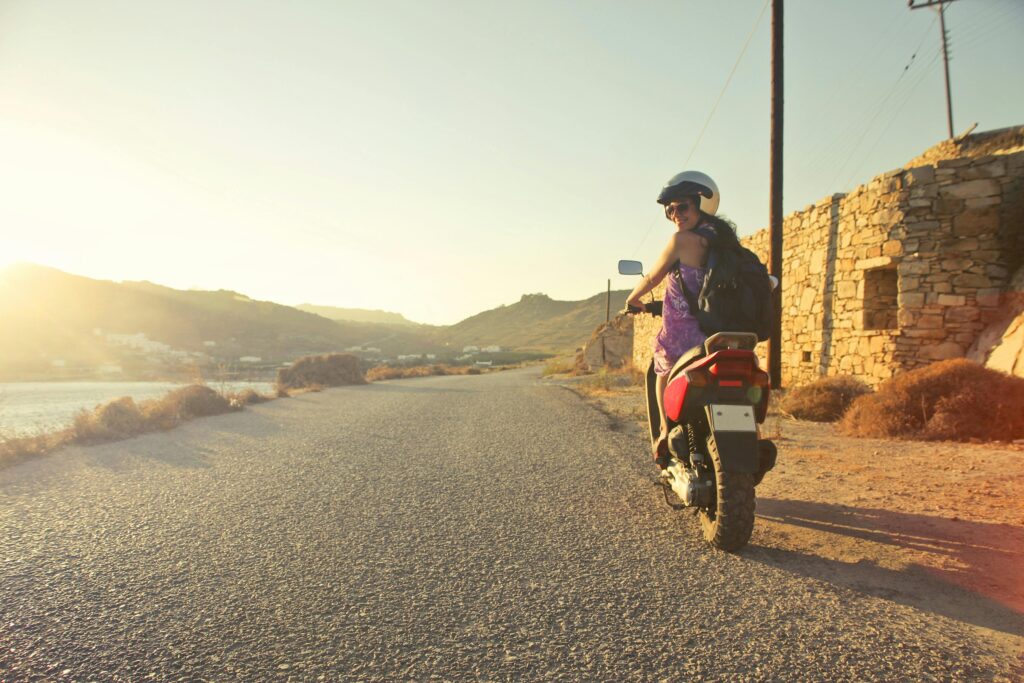 woman on motorbike sunset